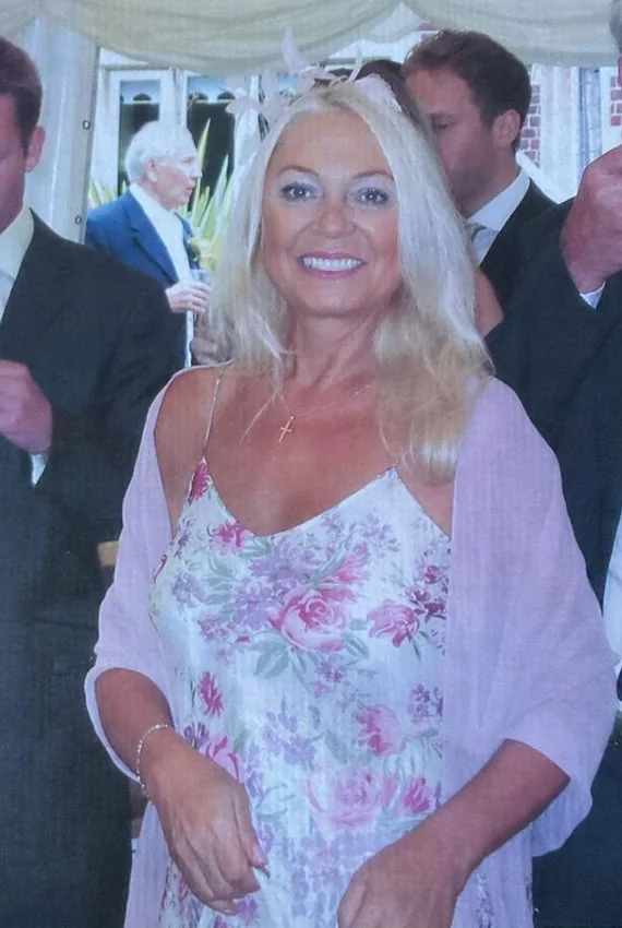 Jenny, Alexa's grandmother, smiling at a family celebration